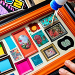 **

A close-up shot of an old picture frame being spray-painted a vibrant color, with various colorful decals and stickers scattered around it. Focus on the transformation from old to new, highlighting the DIY/upcycling aspect. Background slightly blurred to emphasize the frame.

**